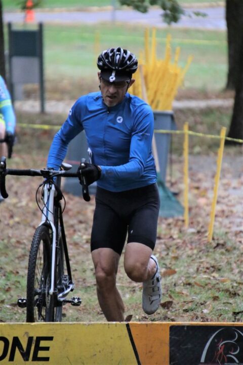 An athlete pushing through physical effort while cycling, symbolizing the mastery of pain and mental resilience during intense physical challenges.